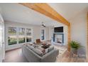 Bright living room featuring a fireplace, ceiling fan, and large windows that fill the space with natural light at 1200 Grace Ave, Kannapolis, NC 28083