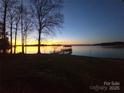 Scenic waterfront view with a charming dock extending into the tranquil water at sunset at 134 Larkhaven Ln, Mooresville, NC 28117