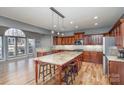 Spacious kitchen featuring wood cabinets, granite countertops, and a large island at 158 Crimson Orchard Dr, Mooresville, NC 28115