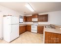 Functional kitchen with wood cabinets, white appliances and ample counter space at 1991 9Th Street Se Pl, Hickory, NC 28602
