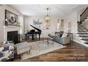 Elegant living room features a cozy fireplace, hardwood floors, and stylish decor at 2033 Folkstone Ln, Indian Land, SC 29720