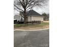 Spacious backyard featuring a wrought iron fence, mature tree and a deck perfect for outdoor enjoyment at 2049 Winding Oak Rd, Rock Hill, SC 29732