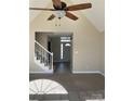 Bright open-concept living room showcasing vaulted ceilings, ceiling fan, carpet floors, and staircase at 2049 Winding Oak Rd, Rock Hill, SC 29732