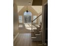 Sun-filled living room boasting vaulted ceilings, a large window, and staircase leading to the upper level at 2049 Winding Oak Rd, Rock Hill, SC 29732