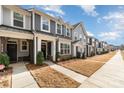 Attractive townhome with gray siding, well-maintained landscaping, sidewalk, and inviting front entry at 2130 Blewett Dr, Charlotte, NC 28269