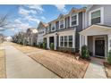 Charming street view featuring townhomes with well maintained lawns, sidewalks, and manicured landscaping at 2130 Blewett Dr, Charlotte, NC 28269