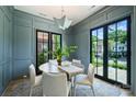 Stylish dining room featuring paneled walls, modern lighting, and doors that lead to a patio at 238 Laurel S Ave # B, Charlotte, NC 28207