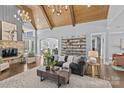 Elegant living room with a stone fireplace, exposed shelving, and an open archway at 2615 Farm House Ln, Monroe, NC 28110