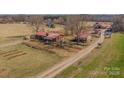 Beautiful aerial shot of a home, barns, and expansive land on a sunny day at 262 Tuckers Grove Rd, Statesville, NC 28625