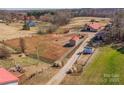 An aerial view showcases a large property with barns and open land at 262 Tuckers Grove Rd, Statesville, NC 28625