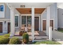 Inviting front porch with rocking chairs, wood ceiling, and stylish architectural design at 2721 Kilgo Way, Charlotte, NC 28205