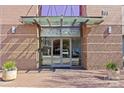 Building entrance featuring glass doors, modern awning, and brick facade in an inviting urban setting at 315 Arlington Ave # 1206, Charlotte, NC 28203