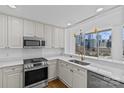 Bright kitchen features quartz countertops, stainless steel appliances, modern faucet, and city skyline views at 315 Arlington Ave # 1206, Charlotte, NC 28203