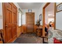 Inviting entryway with wood paneling, bench seating, and view into office space creating a welcoming ambiance at 4009 Polkville Rd, Shelby, NC 28150