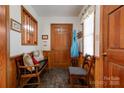 Inviting entryway with wood paneling, bench seating, and coat rack, creating a welcoming ambiance at 4009 Polkville Rd, Shelby, NC 28150