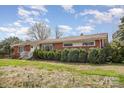 Traditional single story home featuring brick facade, mature landscaping, and covered front porch at 5485 S Nc 16 Hwy, Maiden, NC 28650