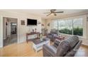 Bright living room features hardwood floors, a ceiling fan, and a large window with outdoor views at 5485 S Nc 16 Hwy, Maiden, NC 28650