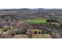 Scenic aerial view showing expansive land with tree cover and a distant home, providing privacy at 5534 Little Mountain Rd, Catawba, NC 28609