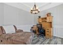 Cozy office space featuring tray ceiling, decorative lighting, hardwood floors and modern furnishings at 571 Rough Hewn Ln, Rock Hill, SC 29730