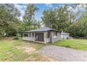 Charming single-story home with a gravel driveway and covered front porch with rocking chairs at 5825 Greene St, Charlotte, NC 28269