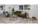Inviting living room featuring large windows, modern décor, and stylish flooring at 5825 Greene St, Charlotte, NC 28269