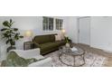 Bright living room with large windows, modern furniture, and hardwood floors at 5825 Greene St, Charlotte, NC 28269