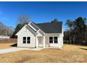 Beautiful exterior shot of a well-maintained house, featuring white siding, complemented by a pristine lawn and clear blue skies at 6756 Denver Heights Cir, Denver, NC 28037