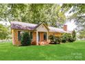 Traditional brick home with well-maintained lawn, featuring a welcoming entrance and established landscaping at 7770 Sherrills Ford Rd, Sherrills Ford, NC 28673