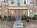 Inviting townhouse front with brick facade, manicured bushes and walkway leading to front door at 832 Imperial Ct, Charlotte, NC 28273