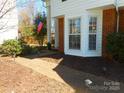 Brick paver path leads to the front door, highlighted by a bay window and American flag at 9331 Hanworth Trace Dr, Charlotte, NC 28277