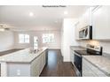 Open-concept kitchen with island, granite countertops, and a clear view of the adjacent living area at 1377 6Th Ne St, Hickory, NC 28601