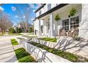 Beautifully landscaped front yard with manicured flowerbeds and a covered front porch at 14625 Harvington Dr, Huntersville, NC 28078