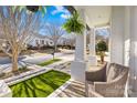Inviting front porch with wicker chairs, hanging ferns, and a view of the neighborhood street at 14625 Harvington Dr, Huntersville, NC 28078