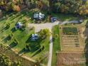 An aerial view of a property with a large home, guest house, and well-manicured grounds at 153 Badenyon Pl, Union Grove, NC 28689