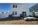 Rear view of home with a white fence, a sliding glass door, and a modest backyard space at 202 J.P. Dr # 183, Albemarle, NC 28001