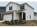 Charming two-story home with white siding, black shutters, and a brick-accented front exterior and a well-manicured lawn at 202 J.P. Dr # 183, Albemarle, NC 28001