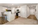 Bright kitchen featuring white cabinets, granite counters, and black appliances at 2026 Talbert Ct, Charlotte, NC 28214