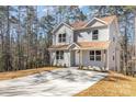 Charming two-story home with gray siding, brown roof, and spacious driveway at 2206 Hillcrest Ave, Albemarle, NC 28001