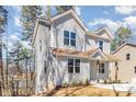 Two-story home with gray siding, brown roof, landscaped yard and a partial basement at 2206 Hillcrest Ave, Albemarle, NC 28001