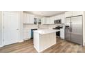 Bright kitchen features white cabinetry, stainless steel appliances, and a center island at 2206 Hillcrest Ave, Albemarle, NC 28001