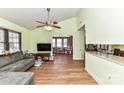 Bright living room featuring wood floors, a vaulted ceiling, and a comfortable gray sofa at 2652 Gabriel Ct, Fort Mill, SC 29715