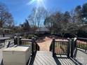 Enjoy the view from the deck overlooking a lush backyard with a charming storage shed at 3240 Sunset Dr, Charlotte, NC 28209