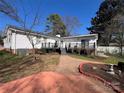 Back of house featuring a black deck, patio, and a well-maintained yard at 3240 Sunset Dr, Charlotte, NC 28209