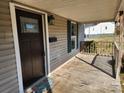 Inviting front porch with wooden deck, dark shutters, and space to enjoy the outdoors at 44 Fenix Sw Dr, Concord, NC 28025