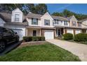 Charming townhouse featuring neutral siding, green shutters, and a one-car garage nestled in a tree-lined community at 4586 Antelope Ln, Charlotte, NC 28269
