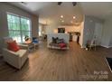 Open floor plan featuring wood flooring, great natural light, and seamless flow to kitchen at 4586 Antelope Ln, Charlotte, NC 28269