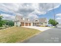 Charming home with a three-car garage and landscaped front yard on a waterfront lot at 627 Birdie Ln # 21/22, Norwood, NC 28128