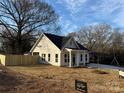 Attractive one-story home with white siding and a well-maintained front yard and wood fence at 803 Fargo Dr, Concord, NC 28027