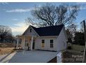 Inviting single-story home features a covered front porch and a long, paved driveway at 803 Fargo Dr, Concord, NC 28027