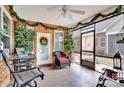 Inviting screened-in porch with comfortable seating, decorative plants, and stylish tile flooring at 8439 Sonata Ct, Denver, NC 28037